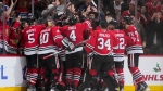 The Chicago Blackhawks celebrate their 4-3 win over the Toronto Maple Leafs after defenseman Kevin Korchinski scored the overtime goal in an NHL hockey game Friday, Nov. 24, 2023, in Chicago. The Blackhawks won 4-3. (AP Photo/Erin Hooley)