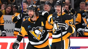 Pittsburgh Penguins' Erik Karlsson (65) celebrates with Kris Letang (58) after scoring during the the second period of an NHL hockey game against the Toronto Maple Leafs in Pittsburgh, Saturday, Nov. 25, 2023. (AP Photo/Gene J. Puskar)