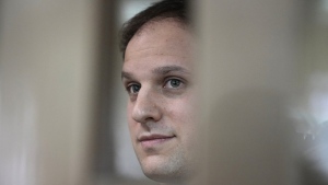 FILE - Wall Street Journal reporter Evan Gershkovich stands in a glass cage in a courtroom at the Moscow City Court in Moscow, Russia, Tuesday, Oct. 10, 2023. A court in Moscow on Tuesday, Nov. 28, extended the detention of Wall Street Journal reporter Gershkovich, arrested on espionage charges, until Jan. 30, Russian news agencies reported. (AP Photo/Alexander Zemlianichenko, File)
