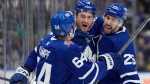Toronto Maple Leafs centre Noah Gregor (18) celebrates his goal against Florida Panthers goaltender Anthony Stolarz with teammates David Kampf (64) and Conor Timmins (25) during second period NHL hockey action in Toronto on Tuesday, Nov. 28, 2023. THE CANADIAN PRESS/Frank Gunn 