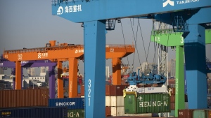 File - A crane lifts a shipping container at an automated container port in Tianjin, China, Jan. 16, 2023. The global economy, which has proved surprisingly resilient this year, is expected to falter next year under the strain of wars, still-elevated inflation and continued high interest rates. (AP Photo/Mark Schiefelbein, File)
