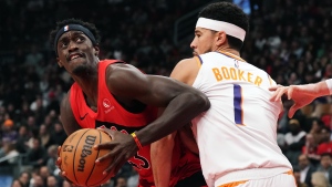 Toronto Raptors' Pascal Siakam (43) tries to get around Phoenix Suns' Devin Booker (1) during first half NBA basketball action in Toronto on Wednesday, November 29, 2023. THE CANADIAN PRESS/Chris Young