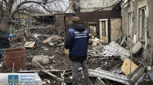In this photo provided by the Donetsk Regional Prosecutor's Office, a war crime prosecutor inspects the scene after shelling in Pokrovsk, Ukraine, Thursday, Nov. 30, 2023. (Ukrainian Donetsk Regional Prosecutor's Office via AP)