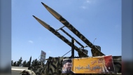 In this file photo, a poster that shows Hezbollah leader Hassan Nasrallah with Arabic writing reading 'more than twenty thousand missile,' is seen on a displayed armoured vehicle in the southern village of Qassimiyeh, Lebanon Wednesday, July 11, 2007. (AP Photo/Mohammed Zaatari) 