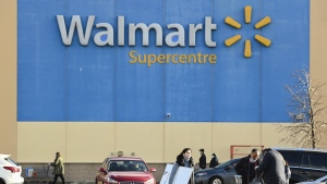 People leave the Walmart after shopping during the COVID-19 pandemic in Mississauga, Ont., Thursday, Nov. 26, 2020. Walmart Canada says it will invest nearly $1 billion this fiscal year on a slew of projects meant to modernize the retail giant's Canadian footprint. THE CANADIAN PRESS/Nathan Denette