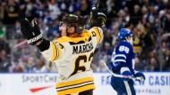 Boston Bruins left wing Brad Marchand (63) celebrates after scoring in overtime to defeat the Toronto Maple Leafs in NHL hockey action, in Toronto on Saturday, Dec. 2, 2023. THE CANADIAN PRESS/Christopher Katsarov