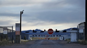 According to a new poll, 79 per cent of Canadians and 84 per cent of Americans reported believing in at least one conspiracy theory. Signs warn about trespassing at an entrance to the Nevada Test and Training Range near Area 51 outside of Rachel, Nev., July 22, 2019. THE CANADIAN PRESS/AP-John Locher