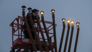 Officials and Jewish leaders are calling on councillors in a city in New Brunswick to reverse their decision against displaying a menorah, marking the start of Hanukkah at sundown this Thursday. A Rabbi lights a giant menorah for Hanukkah in Edmonton, Thursday, Dec. 17, 2020. THE CANADIAN PRESS/Jason Franson
