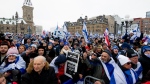 Pro-Israel protestors are seen during a pro-Israel protest on Parliament Hill in Ottawa, on Monday, Dec. 4, 2023. THE CANADIAN PRESS/Spencer Colby