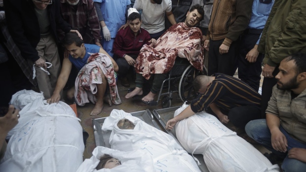 Palestinians mourn over the bodies of their relatives were killed in Israeli bombardments, at the Nasser hospital in Khan Younis refugee camp, southern Gaza Strip, Monday, Dec. 4, 2023. (AP Photo/Mohammed Dahman)