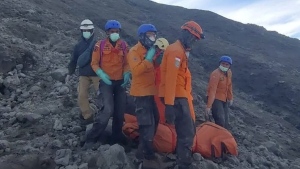 In this undated photo released Dec. 5, 2023, by the Indonesian National Search and Rescue Agency (BASARNAS), rescuers evacuate the body of a climber killed in Mount Marapi's eruption in Agam, West Sumatra, Indonesia. Rescuers searching the hazardous slopes of Indonesia's Marapi volcano found more bodies among the climbers caught by a surprise eruption two days ago. (BASARNAS via AP)
