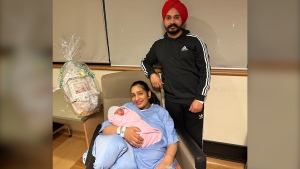 Guneet Jaur with her newborn baby, born at midnight on New Year's Day, is seen in this photograph provided by William Osler Health System. 