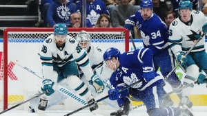 Toronto Maple Leafs forward Mitchell Marner (16) shoots on San Jose Sharks goaltender Kaapo Kahkonen (36) as defenceman Mario Ferraro (38) defends during first period NHL hockey action in Toronto on Tuesday, January 9, 2024. THE CANADIAN PRESS/Nathan Denette