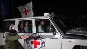 A Red Cross vehicle carrying Israeli hostages drives by at the Gaza Strip crossing into Egypt in Rafah on Saturday, Nov. 25, 2023. (AP Photo/Fatima Shbair, File)