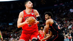 Chicago Bulls centre Nikola Vucevic (9) looks to the net while guarded by Toronto Raptors forward Thaddeus Young (21) during first half NBA basketball action in Toronto on Thursday, January 18, 2024. THE CANADIAN PRESS/Christopher Katsarov