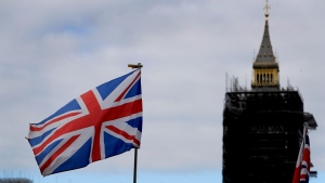 The Union flag flies above a souvenir stand in front of Big Ben in London, Friday, Oct. 16, 2020. (AP Photo/Kirsty Wigglesworth)