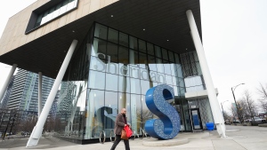 A person walks past Sheridan College's Hazel McCallion Campus in Mississauga, Ont., on Friday, January 26, 2024. Canada will temporarily stop approving student visas so federal and provincial governments can take time to assess the program. THE CANADIAN PRESS/Nathan Denette