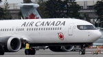 An Air Canada jet is moved on the tarmac at the airport, Wednesday, Nov.15, 2023 in Vancouver. THE CANADIAN PRESS/Adrian Wyld
