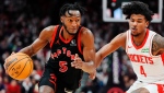 Toronto Raptors guard Immanuel Quickley (5) drives around Houston Rockets guard Jalen Green (4) during second half NBA basketball action in Toronto on Friday, February 9, 2024. THE CANADIAN PRESS/Frank Gunn