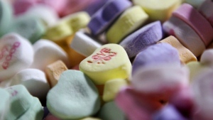 FILE - Colored "Sweethearts" candy is held in bulk prior to packaging at the New England Confectionery Company in Revere, Mass., on Jan. 14, 2009. (AP Photo/Charles Krupa, File)