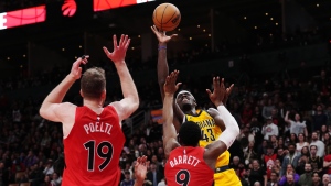 Indiana Pacers forward Pascal Siakam (43) scores over Toronto Raptors guard RJ Barrett (9) as centre Jakob Poeltl (19) looks on during second half NBA basketball action in Toronto on Wednesday, February 14, 2024. THE CANADIAN PRESS/Chris Young