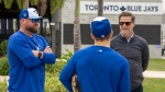 Toronto Blue Jays manager John Schneider, left, and GM Ross Atkins, right, chat with outfielder Daulton Varsho during Spring Training action in Dunedin, Fla., Thursday, Feb. 15, 2024. THE CANADIAN PRESS/Frank Gunn
