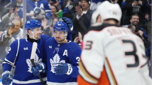 Toronto Maple Leafs' Auston Matthews (centre) is congratulated by Simon Benoit after scoring his third goal against the Anaheim Ducks during second period NHL hockey action in Toronto, on Saturday, February 17, 2024.THE CANADIAN PRESS/Chris Young
