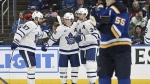 Toronto Maple Leafs' Auston Matthews (34), Mitchell Marner (16) and Timothy Liljegren (37) celebrate after scoring a goal during the second period of an NHL hockey game Monday, Feb. 19, 2024, in St. Louis. (AP Photo/Michael Thomas)