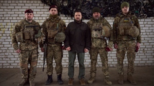 In this photo provided by the Ukrainian Presidential Press Office, Ukrainian President Volodymyr Zelenskyy, centre, pose for a photo with soldiers during his visit to the front line city of Kupiansk, Kharkiv region, Ukraine, Monday, Feb. 19, 2024. (Ukrainian Presidential Press Office via AP) 