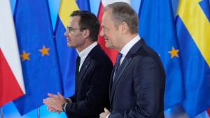 Swedish Prime Minister Ulf Kristersson, left, on a visit to Poland, is greeted by Poland's Prime Minister Donald Tusk, ahead of talks on regional security, NATO and the war in Poland's neighbour, Ukraine, which is fending off Russia's military aggression, in Warsaw, Poland, Monday Feb. 19, 2024. (AP Photo/Czarek Sokolowski) 