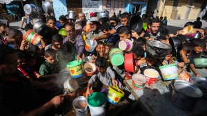 Palestinians crowded together as they wait for food distribution in Rafah, southern Gaza Strip, Wednesday, Nov. 8, 2023. Since the start of the Israel-Hamas war, Israel has limited the amount of food and water allowed to enter the territory, causing widespread hunger across the strip (AP Photo/Hatem Ali)