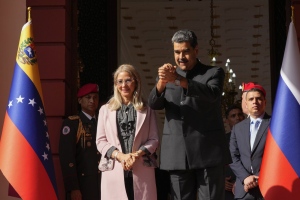 Venezuelan President Nicolas Maduro and first lady Cilia Flores watch Russia's Foreign Minister Sergey Lavrov leave Miraflores presidential palace after their meeting in Caracas, Venezuela, Tuesday, Feb. 20, 2024. (AP Photo/Ariana Cubillos)