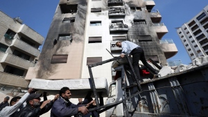 People clean debris after a reported Israeli attack on Syria, in Damascus, Syria, Wednesday, Feb. 21, 2024. (AP Photo/Omar Sanadiki)