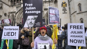 Demonstrators hold banners outside the Royal Courts of Justice in London, Tuesday, Feb. 20, 2024. WikiLeaks founder Julian Assange will make his final appeal against his impending extradition to the United States at the court. (AP Photo/Kirsty Wigglesworth)