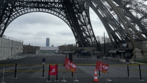 Unions flags are pictured at the Eiffel Tower, Tuesday, Feb. 20, 2024 in Paris. Visitors to the Eiffel Tower were turned away for the second consecutive day because of a strike over poor financial management at one of the world's most-visited sites. (AP Photo/Michel Euler)
