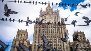 Pigeons take off from wires in front of the Russian Foreign Ministry building, in Moscow, Russia, Thursday, March 29, 2018. (AP Photo/Alexander Zemlianichenko, File)