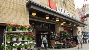 Loblaw Cos. Ltd. reported its fourth-quarter profit and sales rose compared with year ago. A man leaves a Loblaws store in Toronto on Thursday, May 3, 2018. THE CANADIAN PRESS/Nathan Denette