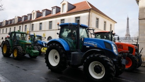 Farmers drive their tractors, Friday, Feb. 23, 2024 in Paris. Angry farmers were back to Paris on their tractors in a new protest demanding more government support and simpler regulations, on the eve of a major agricultural fair in the French capital. (AP Photo/Thomas Padilla)