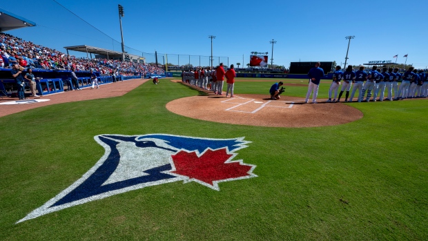 Toronto Blue Jays and Philadelphia Phillies players line up for the anthems prior to Spring Training action in Dunedin, Fla. on Saturday February 24, 2024. THE CANADIAN PRESS/Frank Gunn