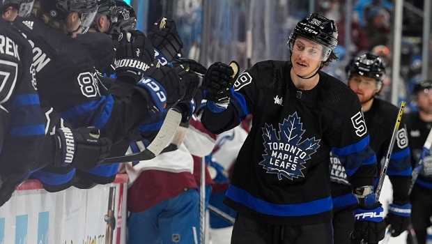 Toronto Maple Leafs left wing Tyler Bertuzzi, right, is congratulated as he passes the team box after scoring his thrid goal of the contest in the third period of an NHL hockey game against the Colorado Avalanche Saturday, Feb. 24, 2024, in Denver. (AP Photo/David Zalubowski)