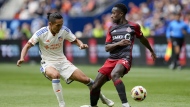 Toronto FC's Richie Laryea, right, loses the ball to FC Cincinnati's Yuya Kubo during the first half of a MLS soccer match in Cincinnati, Sunday, Feb. 25, 2024. THE CANADIAN PRESS/AP-Jeff Dean