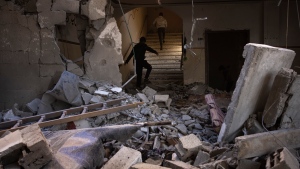 Palestinians check destruction after an Israeli strike in Rafah, Gaza Strip, Saturday, Feb. 24, 2024. (AP Photo/Fatima Shbair)