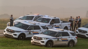 A coroner’s inquest began Monday into the death of Myles Sanderson, who killed 11 people and injured 17 others during a mass stabbing on the James Smith Cree Nation and in a nearby village in Saskatchewan. Police and investigators gather at the side of the road outside Rosthern, Sask., on Wednesday, Sept. 7, 2022, as Sanderson is taken into custody. THE CANADIAN PRESS/Heywood Yu
