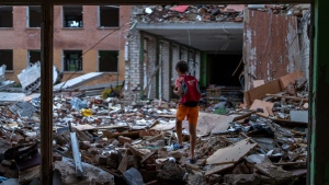 Ivan Hubenko, 11, walks on the bombed-out rubble of his former school in Chernihiv, Ukraine on Aug. 30, 2022. (Emilio Morenatti / AP Photo)