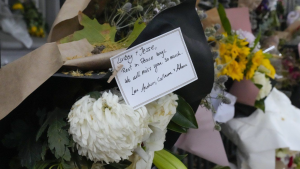 A note is attached to a floral tribute outside the Paddington residence of Jesse Baird in Sydney, Tuesday, Feb. 27, 2024.  (AP Photo/Mark Baker)