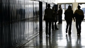 Students walk down a hallway at a high school in Iowa, Dec. 19, 2006. West Virginia's Republican-majority Senate green-lit a bill Tuesday, Feb. 27, 2024, that would make a video on fetal development funded by an anti-abortion group to be required viewing in public schools. (Scott Morgan/The Hawk Eye via AP, File)