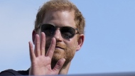 FILE - Britain's Prince Harry, The Duke of Sussex, waves during the Formula One U.S. Grand Prix auto race at Circuit of the Americas, on Oct. 22, 2023, in Austin, Texas. Prince Harry was not improperly stripped of his publicly funded security detail during visits to Britain after he gave up his status as a working member of the royal family and moved to the U.S., a London judge ruled Wednesday Feb. 28, 2024. (AP Photo/Nick Didlick, File)

