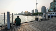 FILE - A man sits on a pier near the Harbourfront Centre in Toronto, on Wednesday, June 28, 2023. THE CANADIAN PRESS/Andrew Lahodynskyj 