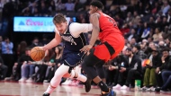 Dallas Mavericks' Luka Doncic drives at Toronto Raptors' RJ Barrett during second half NBA basketball action in Toronto on Wednesday, February 28, 2024. THE CANADIAN PRESS/Chris Young
