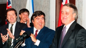 Prime Minister Brian Mulroney is greeted with applause by Conservative Campaign Committee chairman Consumer Affairs Minister Pierre Blais and John Tory (right to left) in Ottawa, ON Nov. 23, 1992. (THE CANADIAN PRESS/Fred Chartrand) 